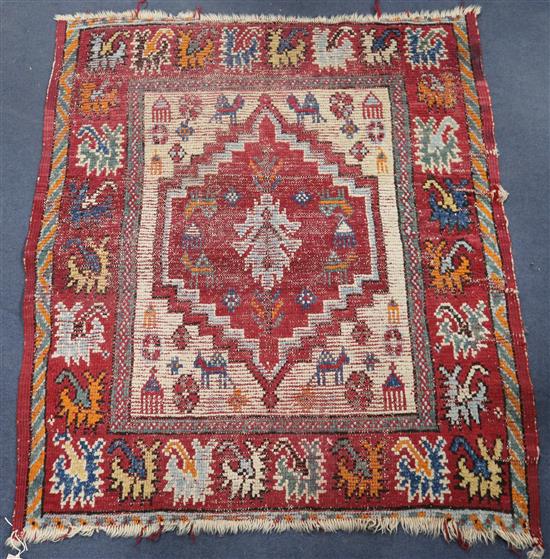 A Caucasian small red medallion rug 105cm x 95cm